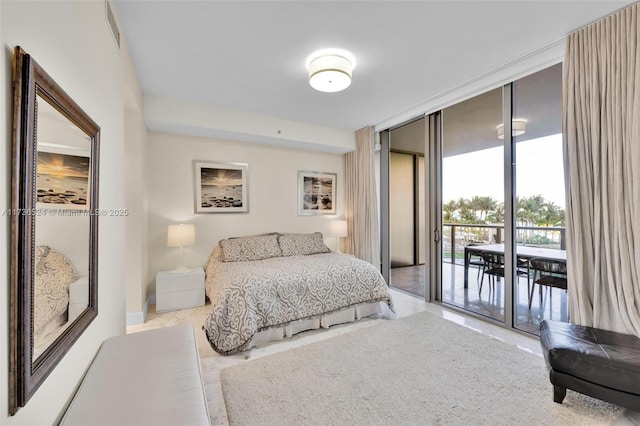 bedroom with floor to ceiling windows and access to outside