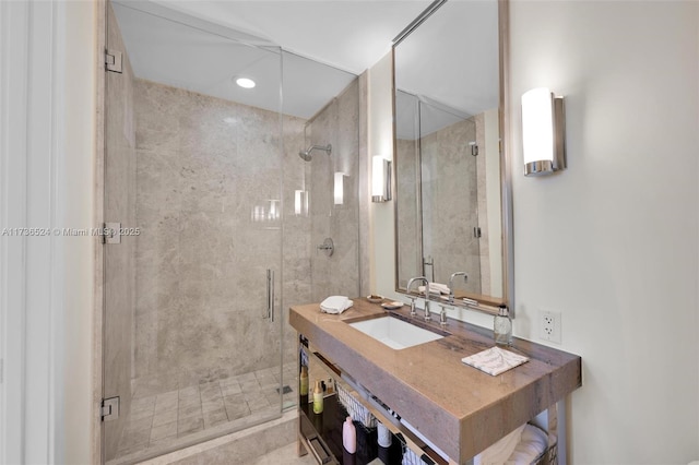 bathroom with vanity and a shower with door