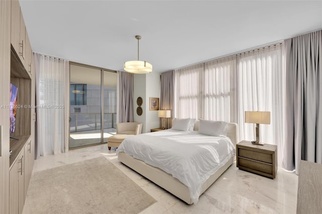 bedroom featuring floor to ceiling windows and access to exterior