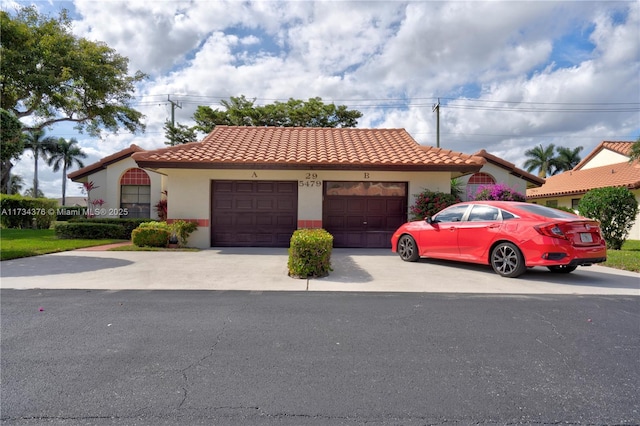 mediterranean / spanish house with a garage