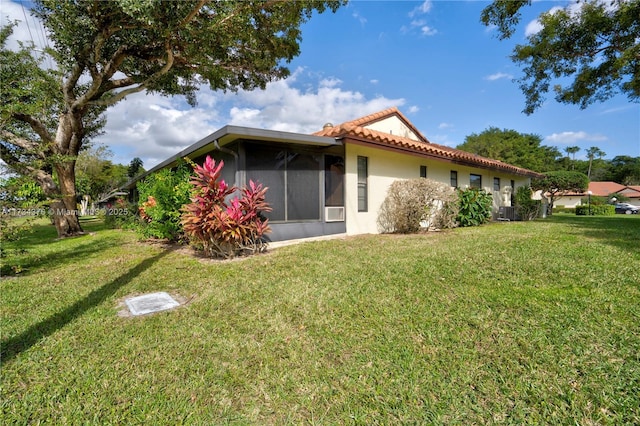 back of house with a lawn