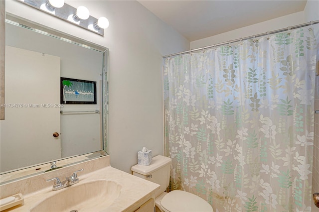 bathroom with vanity, toilet, and a shower with shower curtain