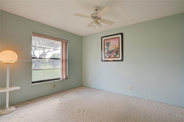 unfurnished room with ceiling fan, carpet floors, and a textured ceiling