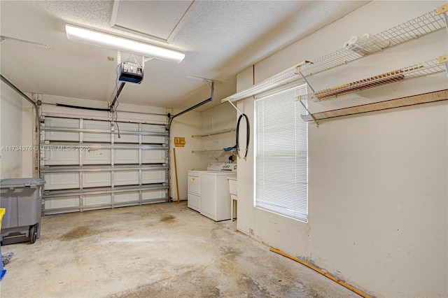 garage with a garage door opener and washing machine and dryer