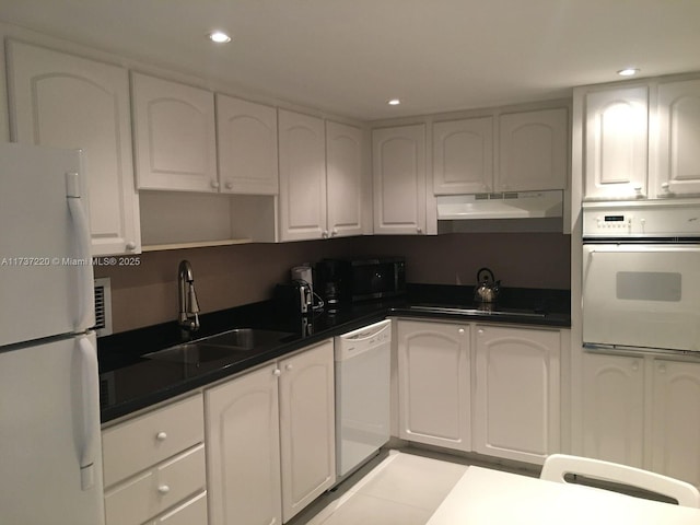 kitchen featuring white cabinetry, sink, and black appliances