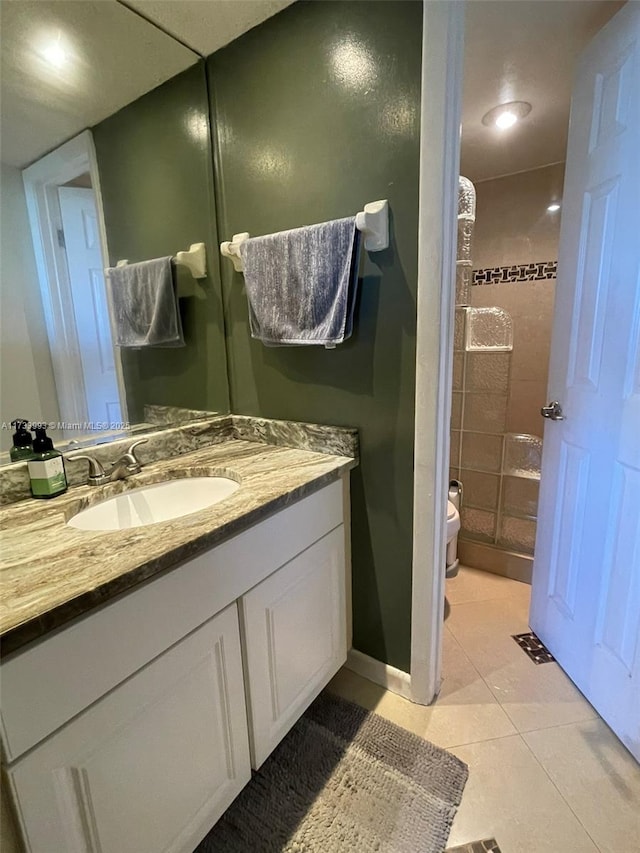 bathroom with vanity, tile patterned floors, and toilet