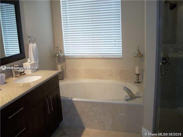 bathroom with vanity and plus walk in shower