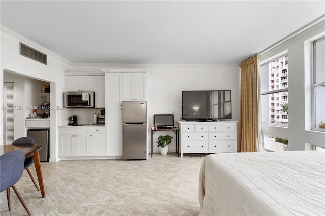 bedroom featuring crown molding, fridge, and stainless steel refrigerator