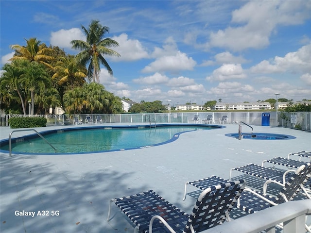 view of pool featuring a hot tub