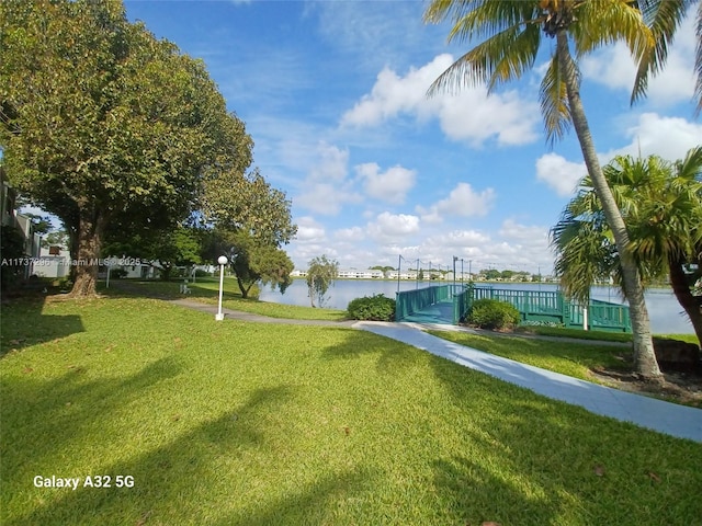 view of home's community featuring a yard and a water view