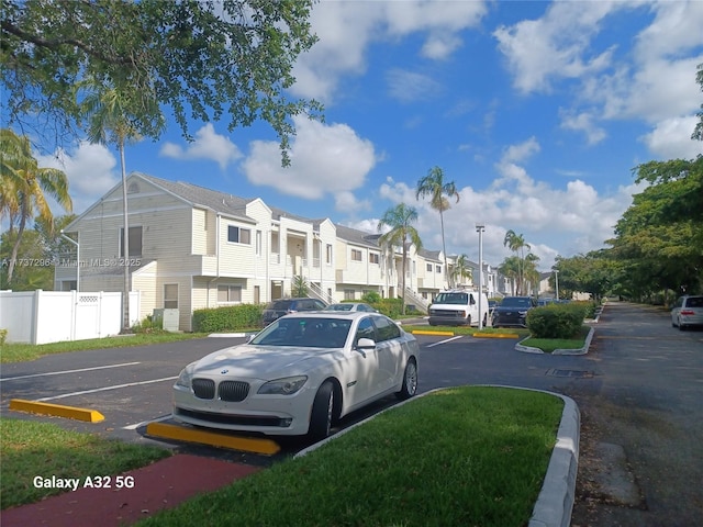 3437 NW 44th St Unit 102, Oakland Park, FL 33309 - uncovered parking lot featuring a residential view