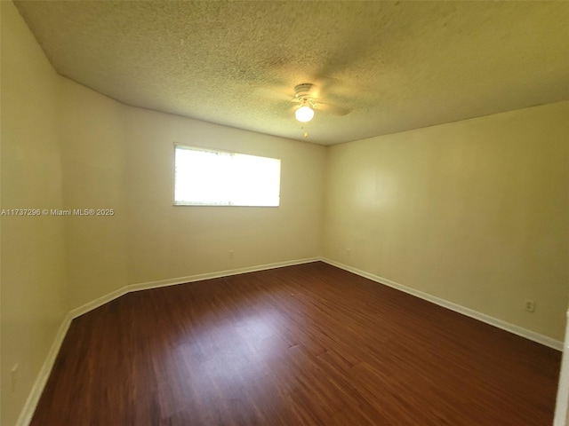 spare room featuring ceiling fan, dark hardwood / wood-style flooring, and a textured ceiling