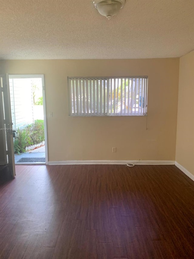 3437 NW 44th St Unit 102, Oakland Park, FL 33309 - empty room featuring wood finished floors, a textured ceiling, and baseboards