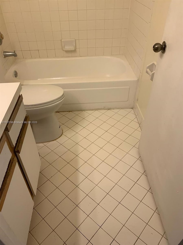 3437 NW 44th St Unit 102, Oakland Park, FL 33309 - bathroom featuring tile patterned flooring, vanity, toilet, and bathing tub / shower combination