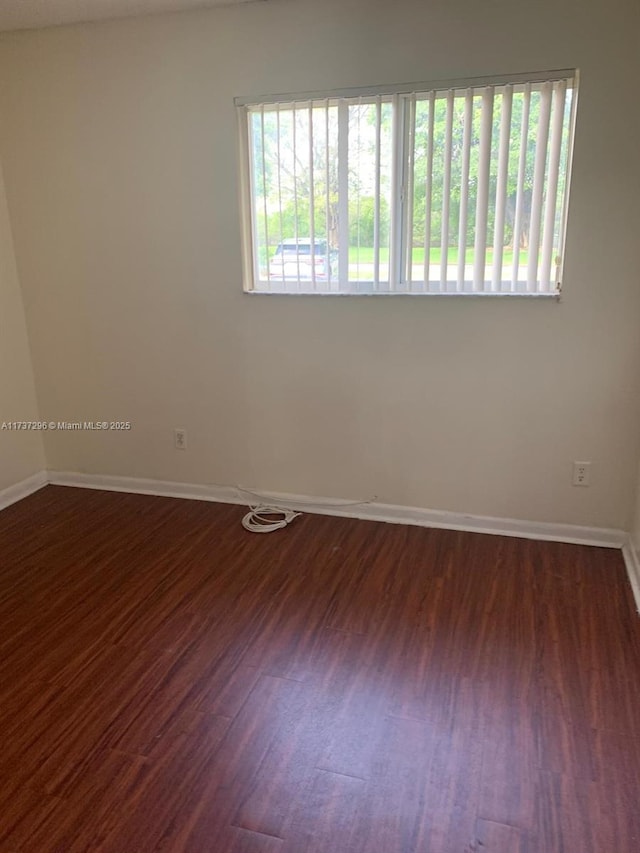 unfurnished room featuring dark hardwood / wood-style floors