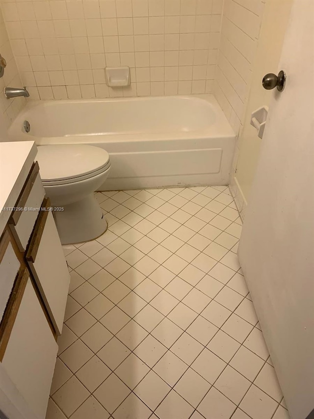 bathroom featuring vanity, toilet, and tile patterned flooring