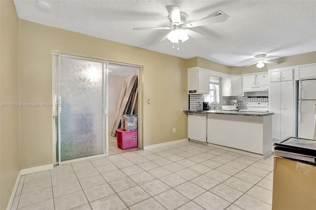 kitchen featuring white appliances, ceiling fan, tasteful backsplash, white cabinets, and dark stone counters