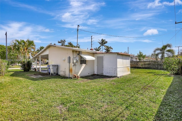 back of property with a lawn