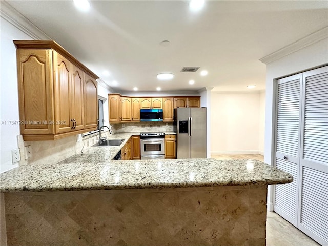 kitchen featuring sink, crown molding, kitchen peninsula, and appliances with stainless steel finishes