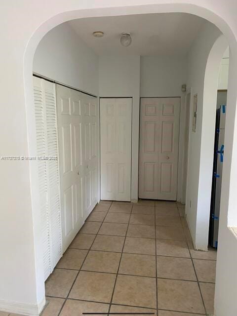 359 Meridian Ave Unit A207, Miami Beach, FL 33139 - hallway with light tile patterned floors and arched walkways