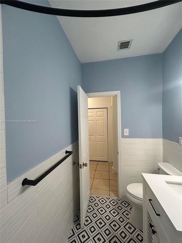359 Meridian Ave Unit A207, Miami Beach, FL 33139 - bathroom with vanity, a wainscoted wall, tile walls, and tile patterned flooring