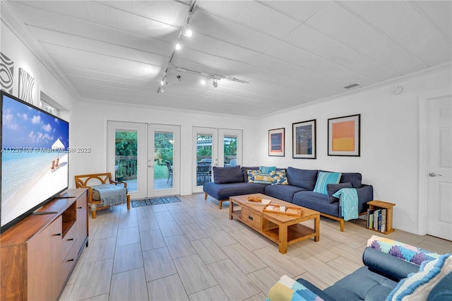 living room featuring crown molding and french doors