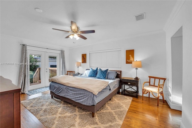 bedroom with access to exterior, ceiling fan, crown molding, light wood-type flooring, and french doors