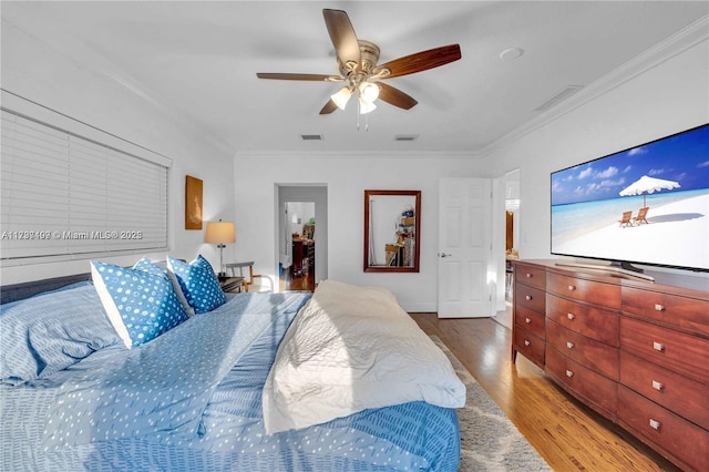 bedroom featuring crown molding, ceiling fan, and light hardwood / wood-style floors