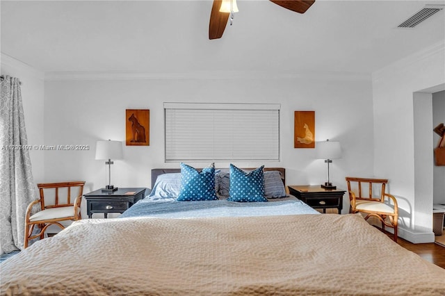 bedroom with hardwood / wood-style floors, crown molding, and ceiling fan