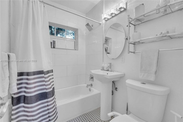 bathroom with shower / tub combo and toilet