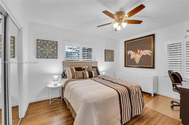 bedroom featuring radiator, hardwood / wood-style floors, and ceiling fan