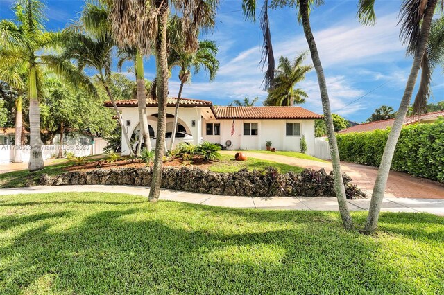 mediterranean / spanish-style home featuring a front lawn