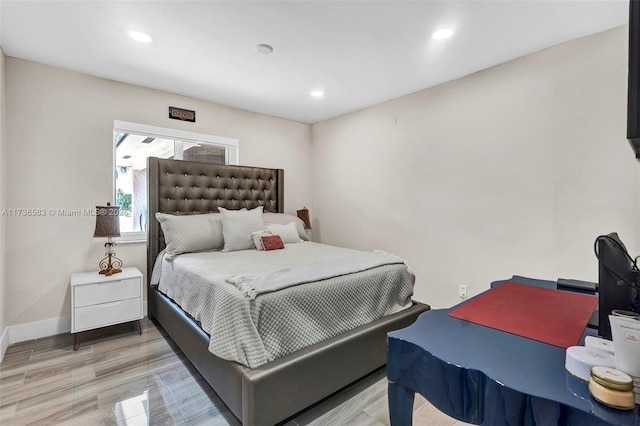 bedroom with recessed lighting, light wood-type flooring, and baseboards