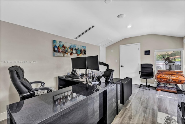 office area with wood finished floors, baseboards, and vaulted ceiling