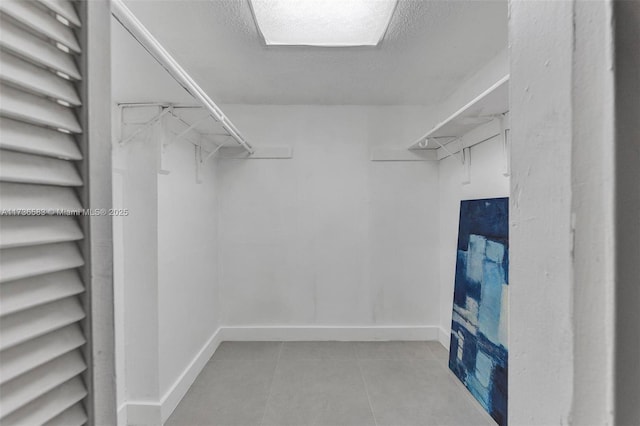 walk in closet featuring tile patterned flooring