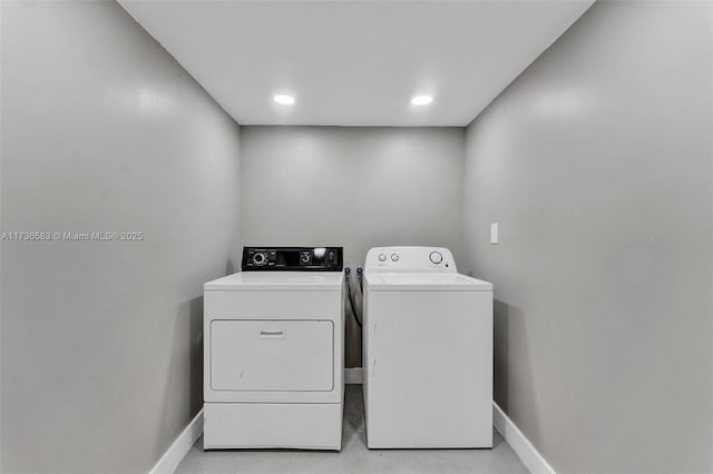 laundry area featuring baseboards, laundry area, and washing machine and clothes dryer