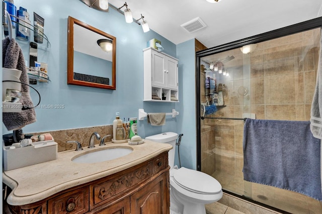 bathroom featuring vanity, visible vents, a stall shower, tile patterned floors, and toilet