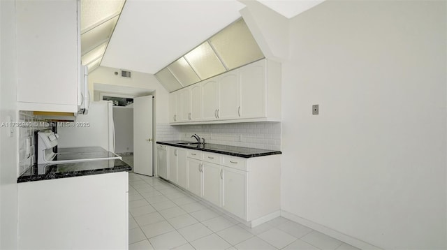 kitchen with white cabinetry, sink, range, and tasteful backsplash