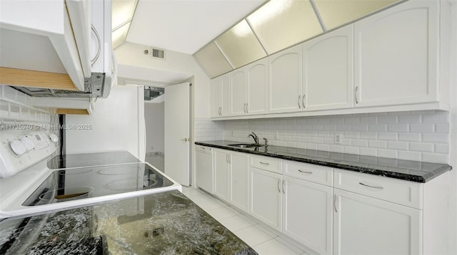 kitchen with tasteful backsplash, electric stove, sink, white cabinetry, and dark stone countertops