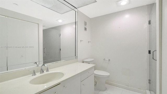 bathroom featuring vanity, an enclosed shower, toilet, and tile patterned floors