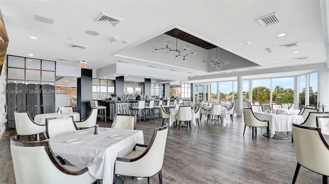 dining space featuring hardwood / wood-style floors and a tray ceiling