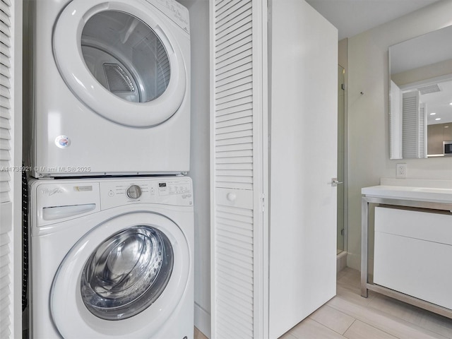 laundry area with stacked washer and clothes dryer