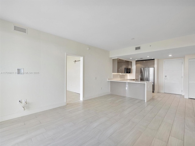 unfurnished living room with sink