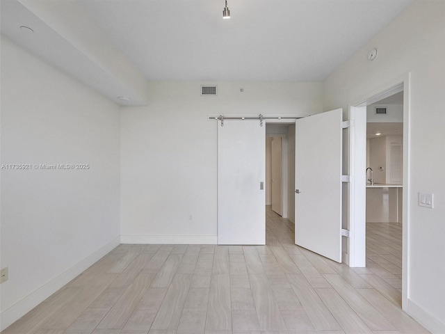 spare room with a barn door