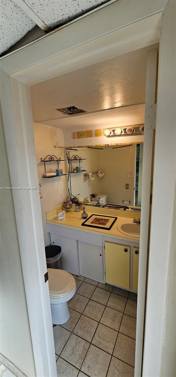 bathroom with tile patterned floors, vanity, and toilet