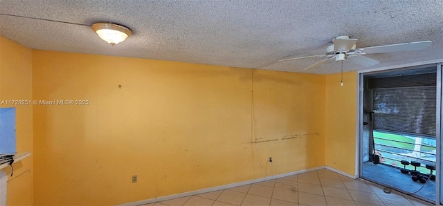 tiled empty room with ceiling fan and a textured ceiling