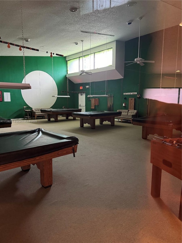 recreation room featuring billiards, a towering ceiling, carpet, and a textured ceiling