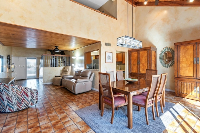 dining room with wood ceiling and light tile patterned floors