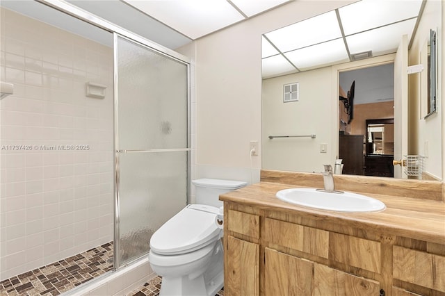 bathroom with vanity, walk in shower, and toilet