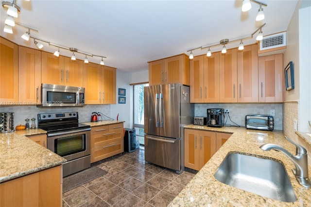 6619 Burning Wood Dr Unit 274, Boca Raton, FL 33433 - kitchen featuring appliances with stainless steel finishes, track lighting, a sink, tasteful backsplash, and light stone countertops